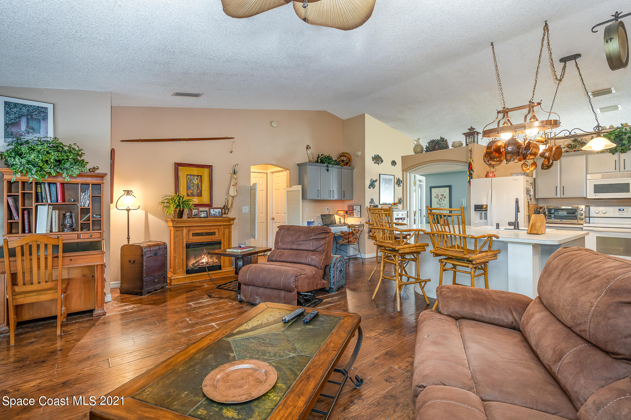6330 Irving Road Cocoa, FL 32927 - Photo 11 of 22 a living room with furniture a dining table and chairs with wooden floor
