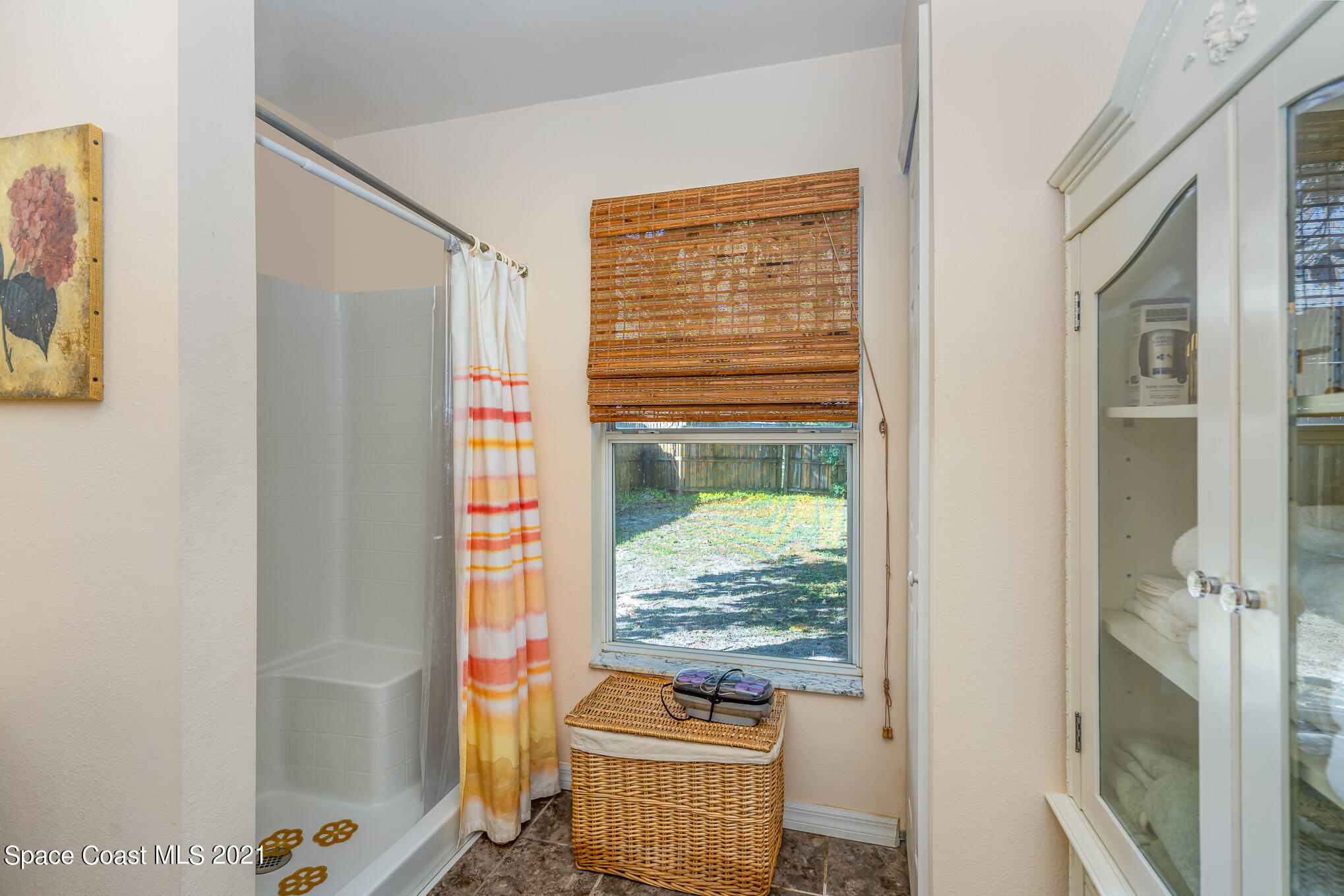 6330 Irving Road Cocoa, FL 32927 - Photo 19 of 22 a view of living room with a floor to ceiling window and wooden floor