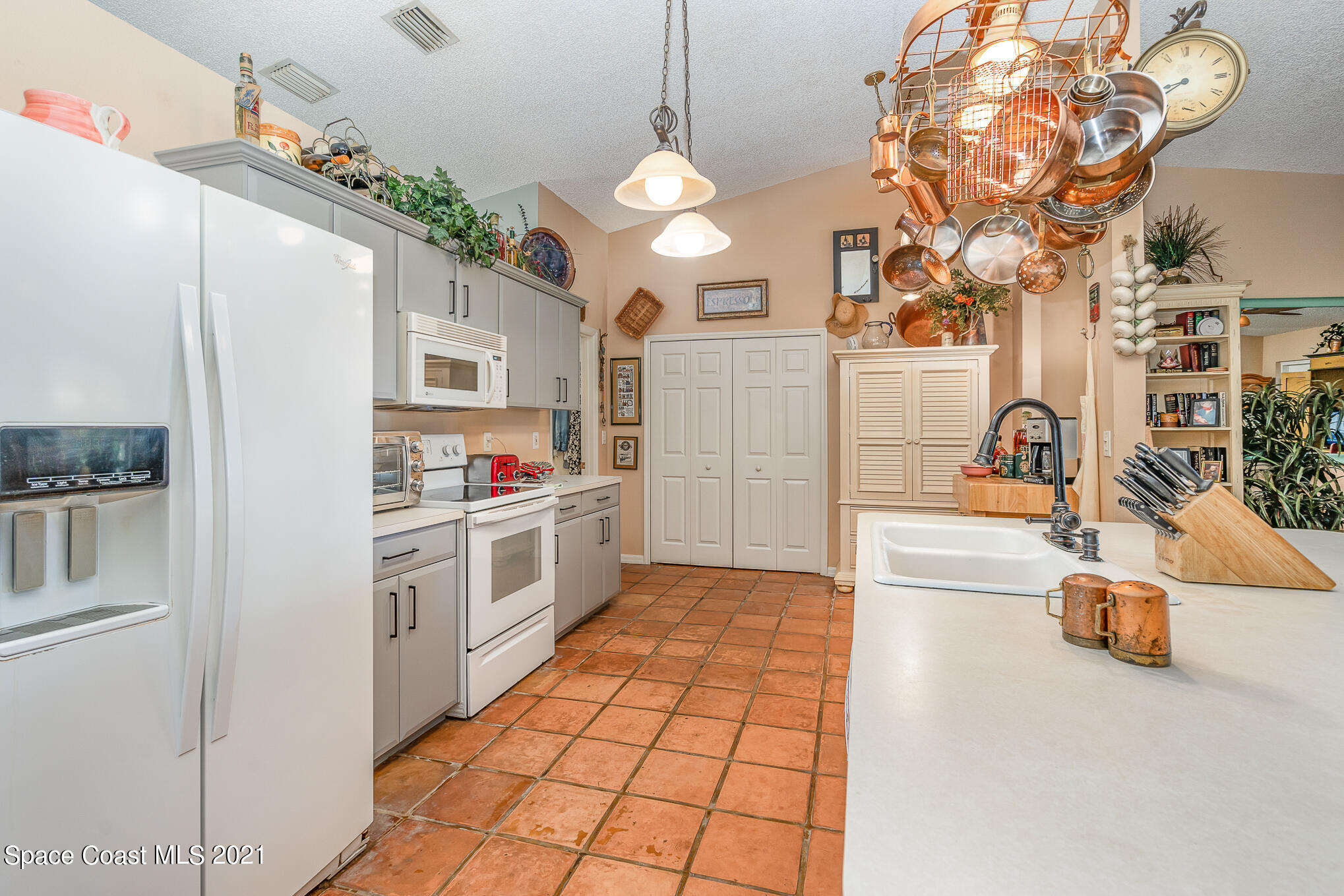 6330 Irving Road Cocoa, FL 32927 - Photo 6 of 22 a kitchen with stainless steel appliances granite countertop a sink a stove and a refrigerator