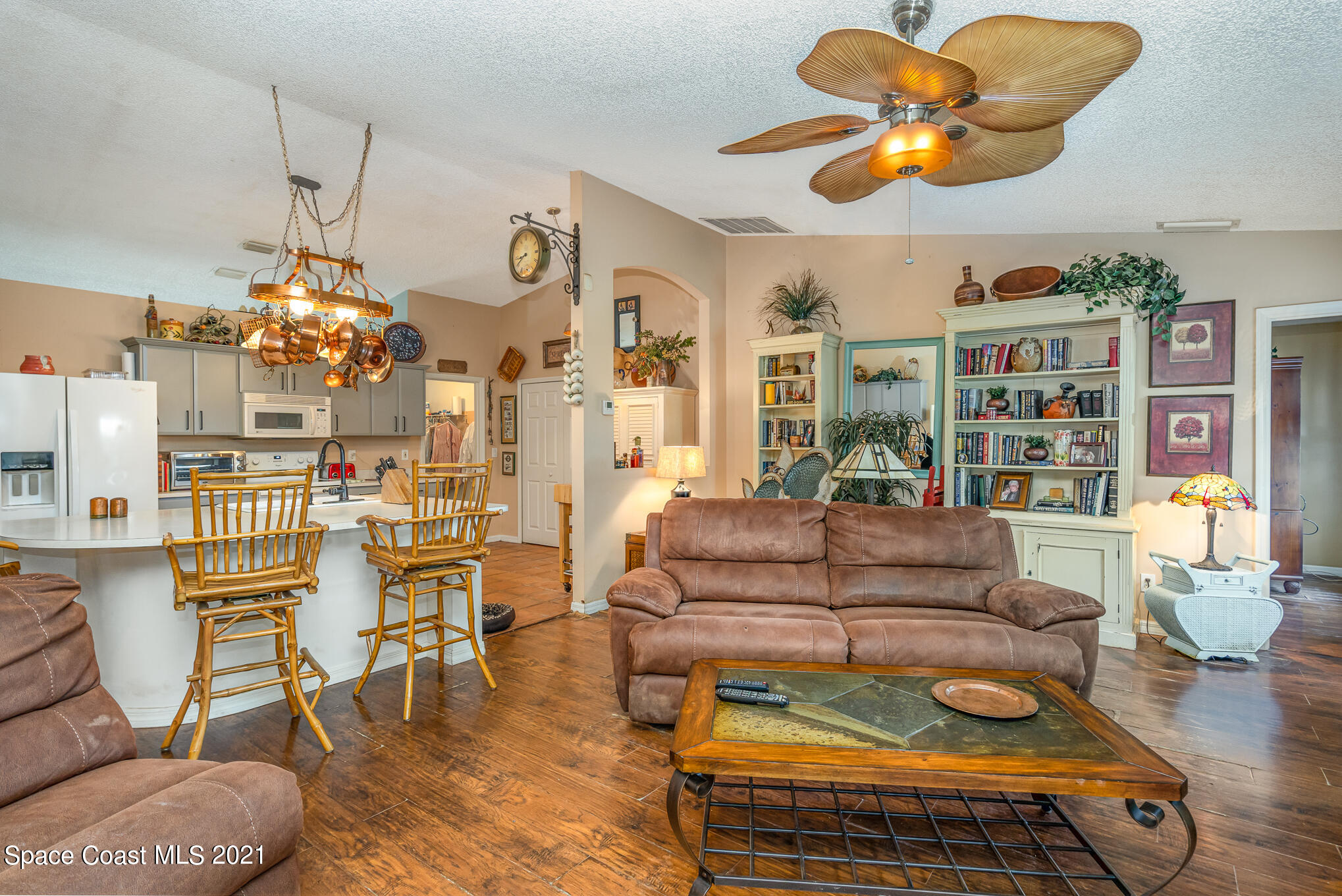 6330 Irving Road Cocoa, FL 32927 - Photo 10 of 22 a living room with furniture a chandelier and a dining table