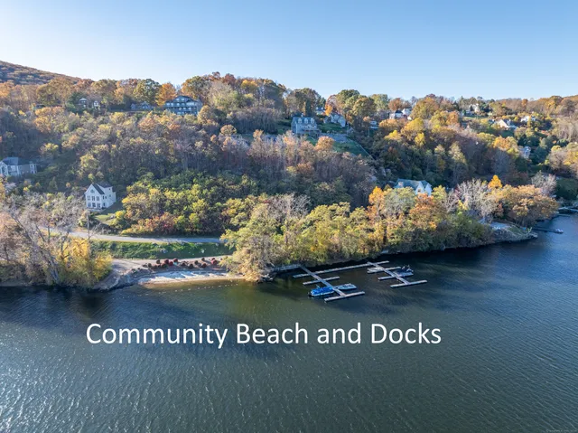 a view of a lake with lawn chairs