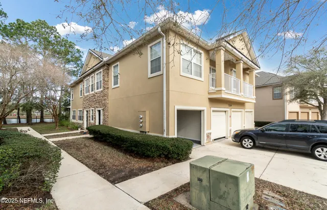 a car parked in front of a white house