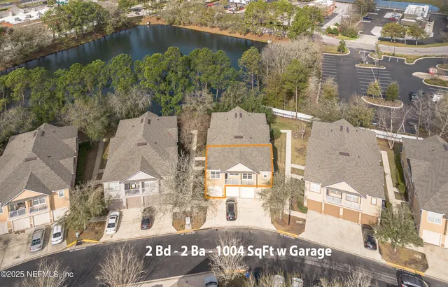 an aerial view of residential houses with outdoor space