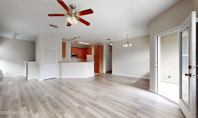 a view of a kitchen with a sink and a cabinet wooden floor