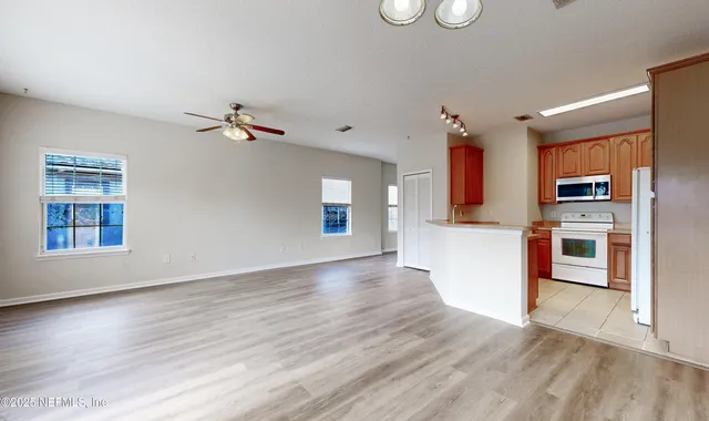 a view of a kitchen with a sink cabinets and wooden floor