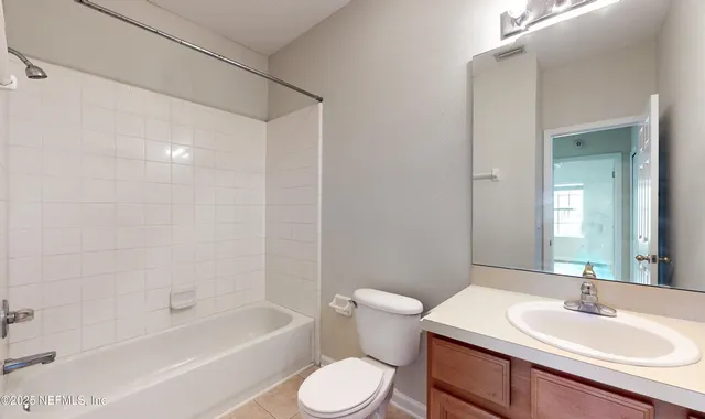 a bathroom with a sink toilet a mirror and shower