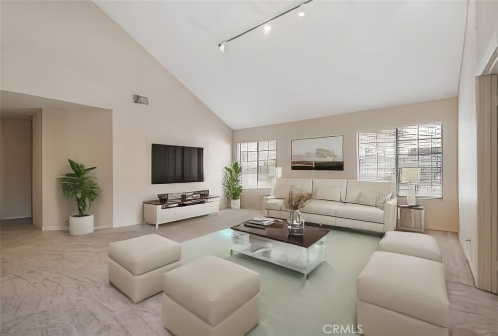 18782 Willowtree Lane Porter Ranch, CA 91326 - Photo 10 of 33 a living room with furniture and a flat screen tv