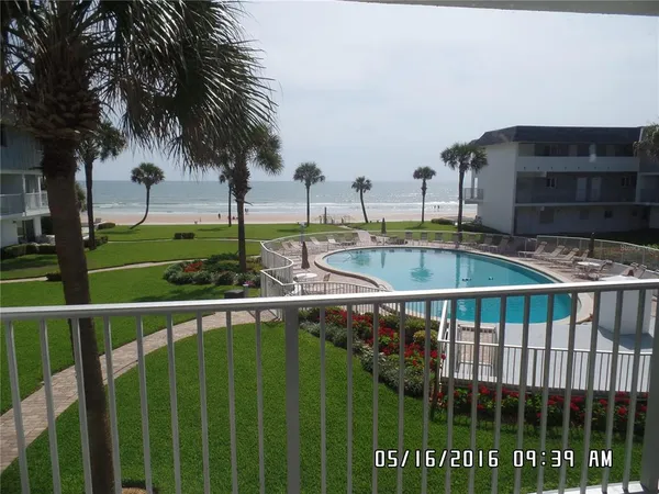 a view of a balcony with floor to ceiling window and wooden fence
