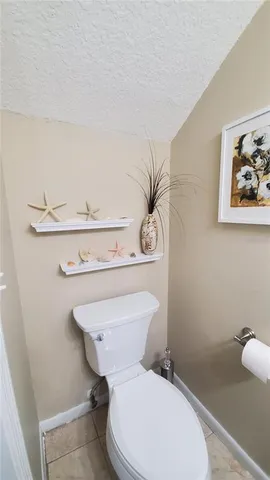 a white toilet sitting next to a bathroom sink