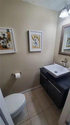 a room with a toilet a sink and mirror