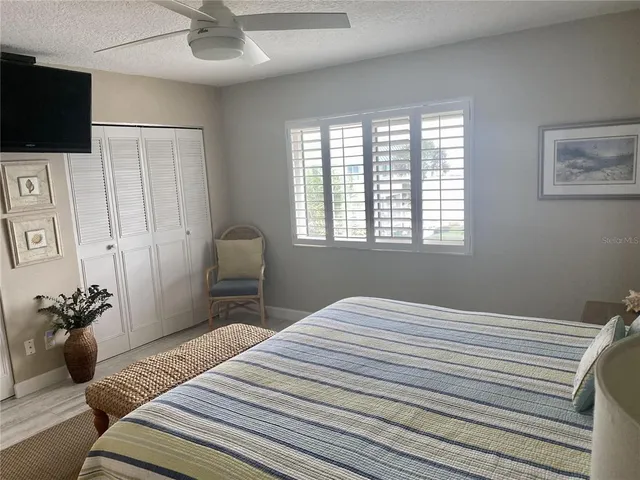 a bedroom with a bed and a television