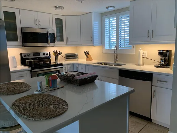 a kitchen with a sink a stove and a microwave