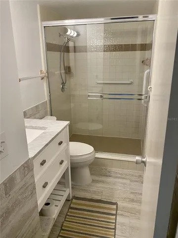a bathroom with a toilet a sink and shower
