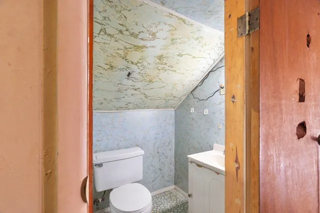 a bathroom with a toilet and a shower