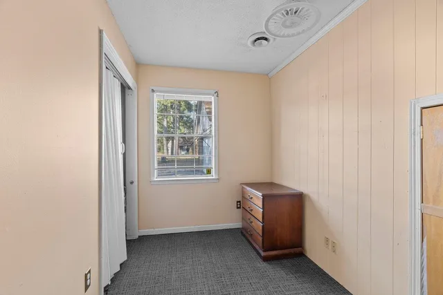 a view of room with window and hallway
