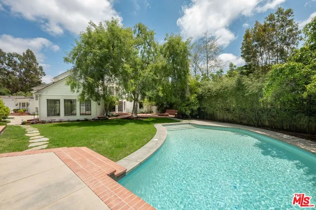 front view of a brick house with a yard