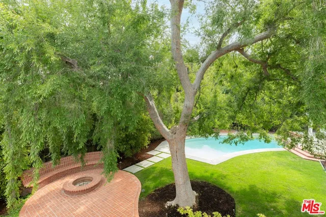 a view of a house with a yard and potted plants