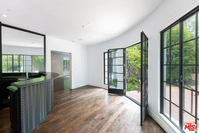 a living room with a table and wooden floor