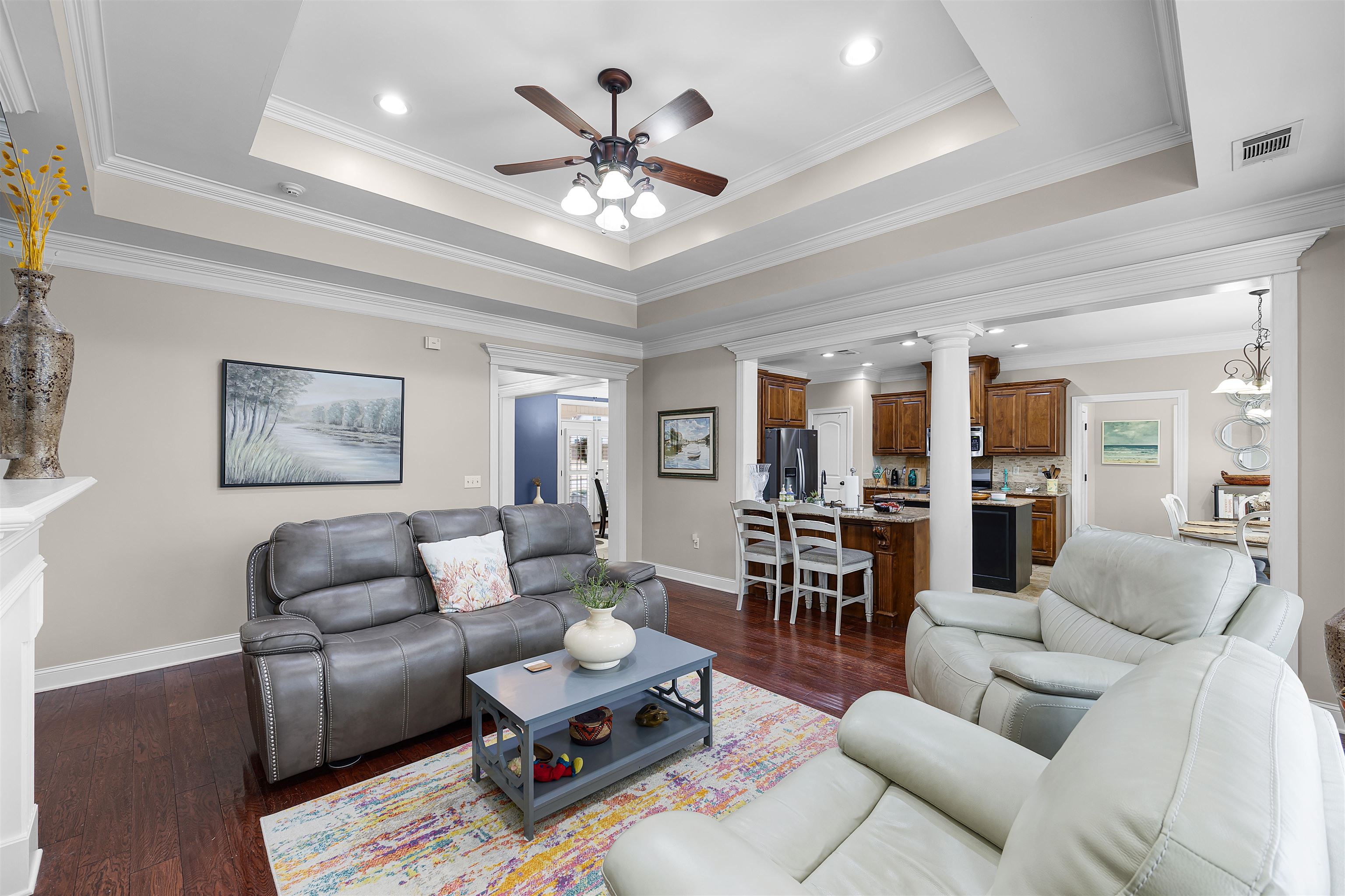 3285 Shadowood Lane Corinth, MS 38834 - Photo 8 of 30 Living area featuring dark wood-style flooring, ceiling fan, crown molding, recessed lighting, and a tray ceiling