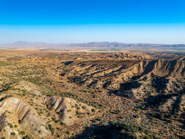 an aerial view of residential building and ocean