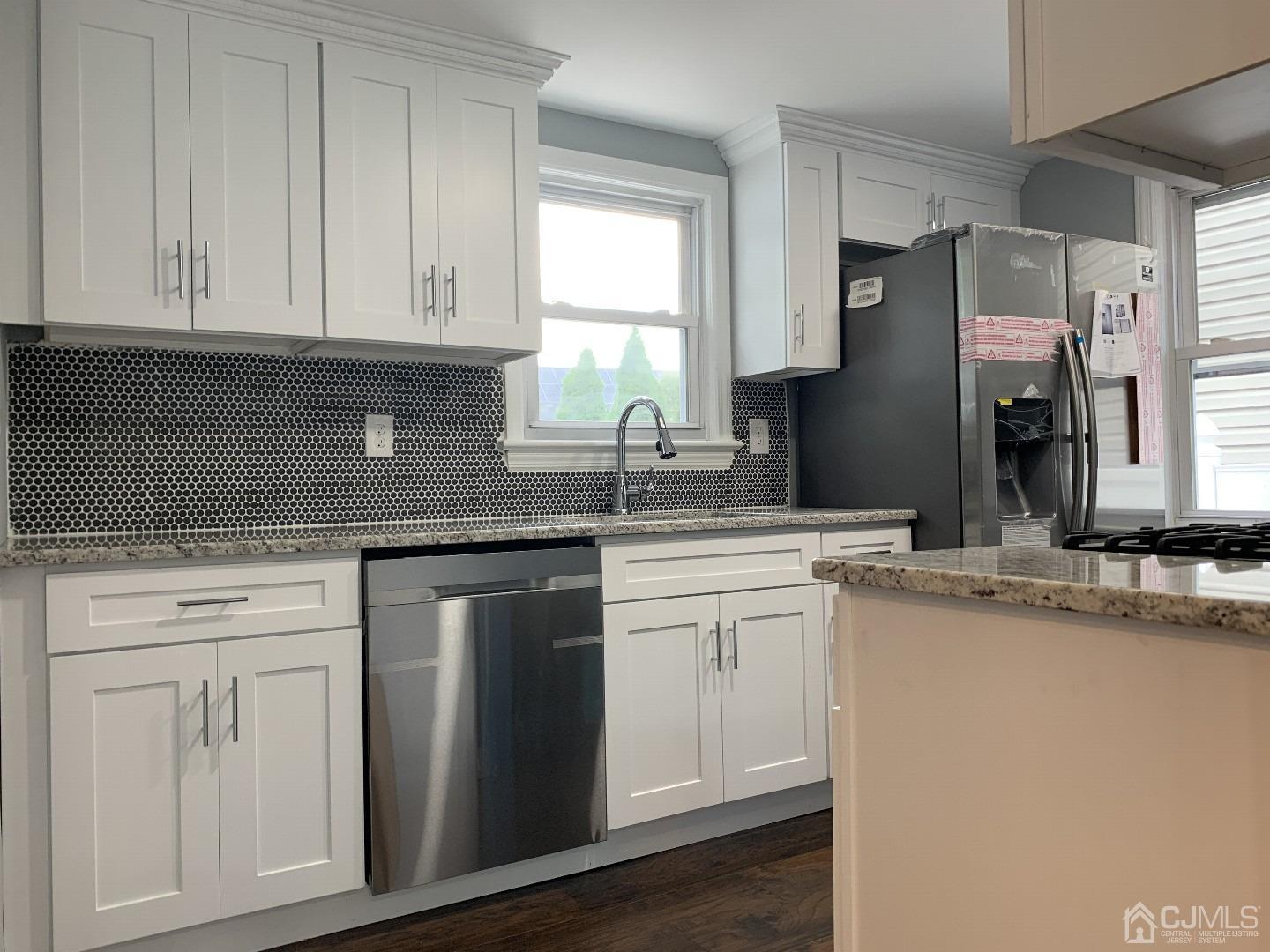 180 East Cliff Road Colonia, NJ 07067 - Photo 3 of 6 a kitchen with stainless steel appliances granite countertop a sink a stove and a refrigerator