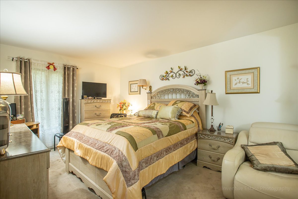 4224 Saratoga Avenue, Unit J105 Downers Grove, IL 60515 - Photo 12 of 20 a bed room with bed and a couch