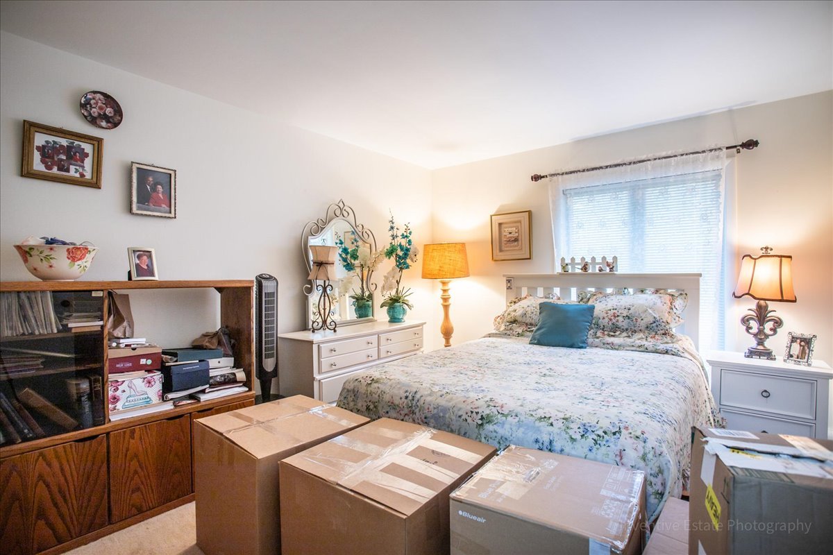 4224 Saratoga Avenue, Unit J105 Downers Grove, IL 60515 - Photo 15 of 20 a bedroom with a bed and a cabinets