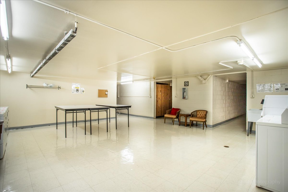 4224 Saratoga Avenue, Unit J105 Downers Grove, IL 60515 - Photo 17 of 20 a room with furniture and a table