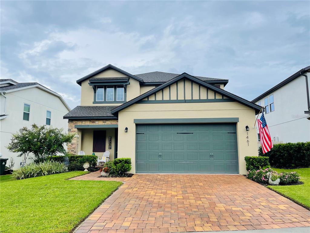 a front view of a house with a yard and garage