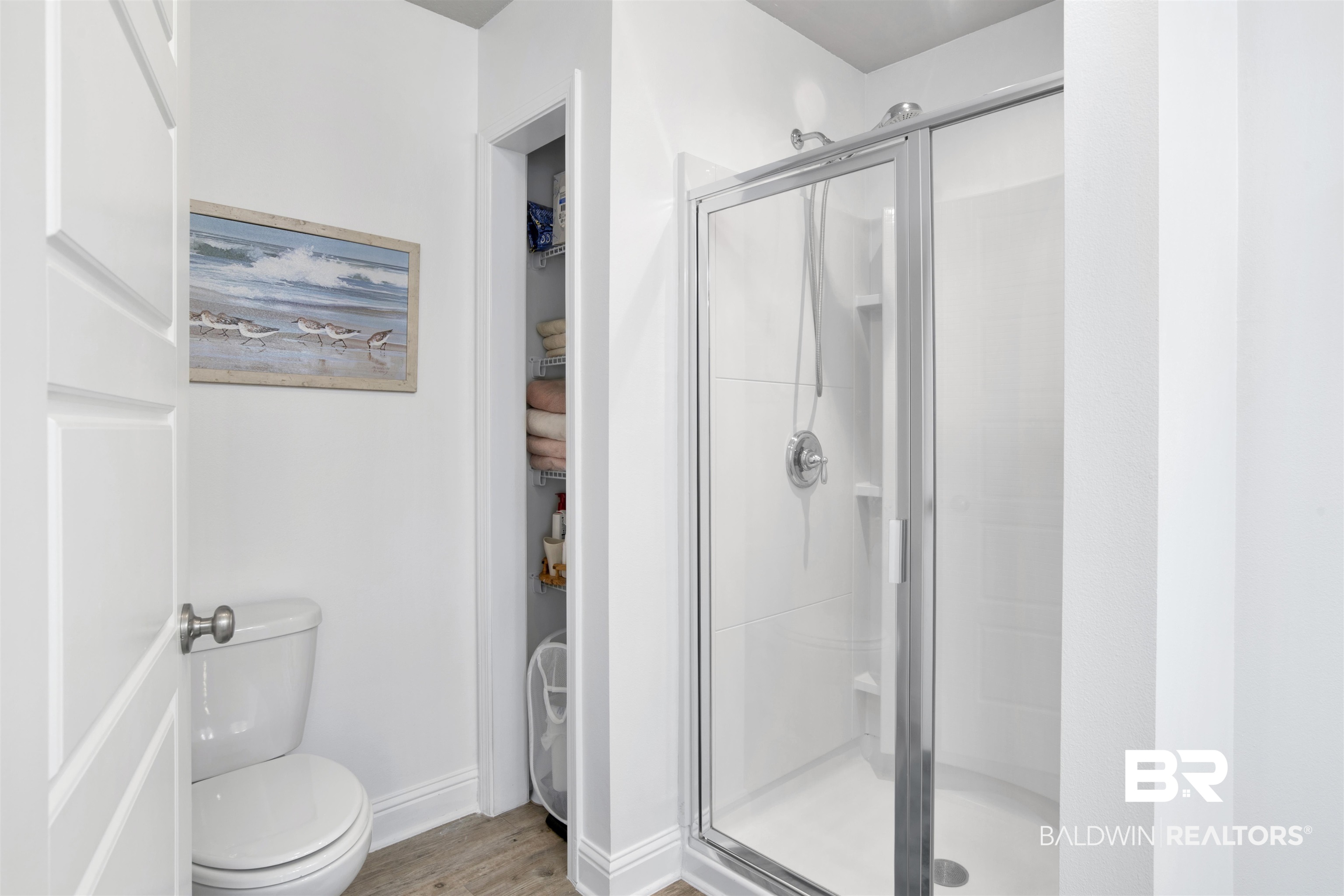 25806 Pollard Road, Unit 20 Daphne, AL 36526 - Photo 17 of 29 Bathroom featuring a shower with shower door, toilet, and hardwood / wood-style floors