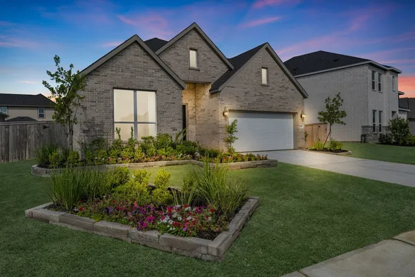 a front view of a house with a garden