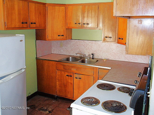 3211 Kline Road Jacksonville, FL 32246 - Photo 2 of 10 a kitchen with a refrigerator and a stove