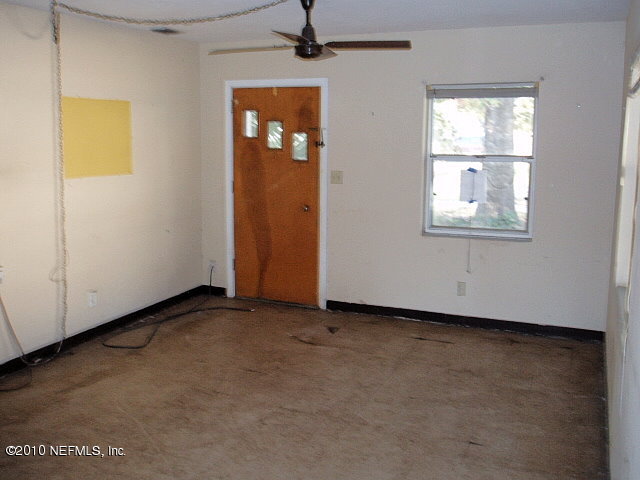 3211 Kline Road Jacksonville, FL 32246 - Photo 4 of 10 an empty room with windows