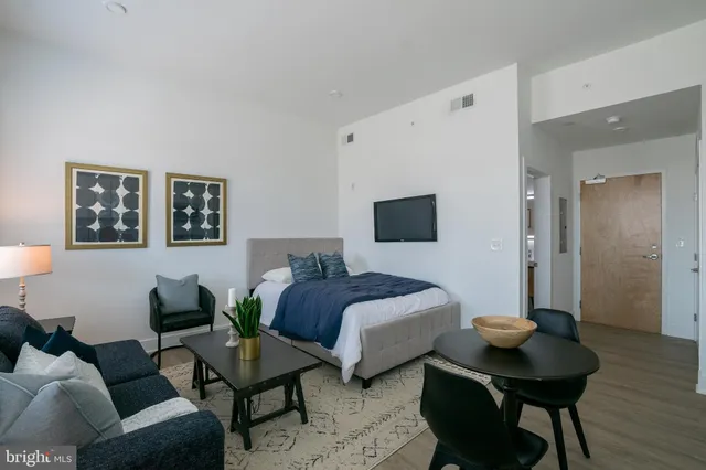 a spacious bedroom with a bed and a table