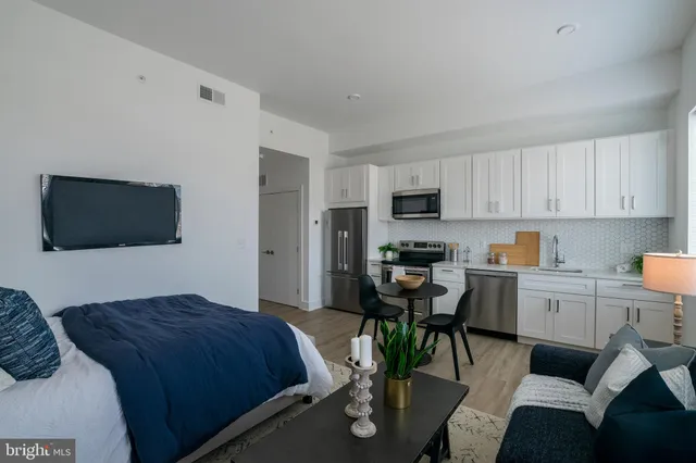 a bedroom with a bed and a television