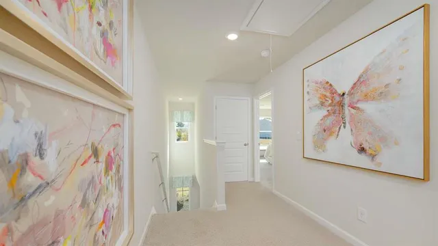 a view of a hallway with paintings on the wall