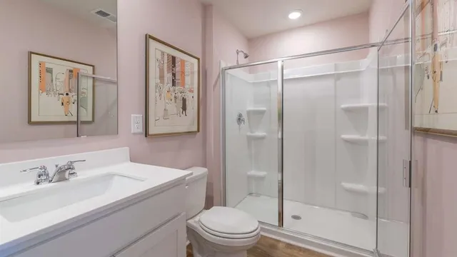 a bathroom with a sink toilet and shower