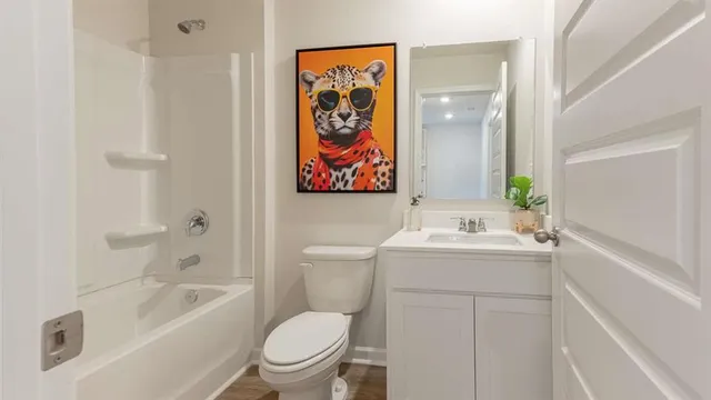 a bedroom with a bed and a painting on the wall