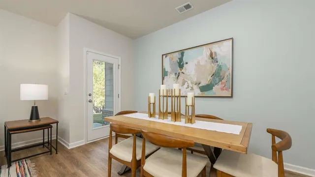 a view of a dining room with furniture and wooden floor