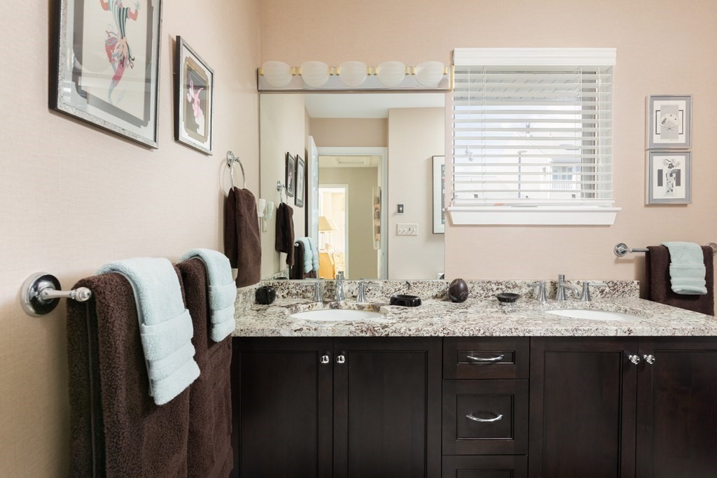 39 Harbourside Road, Unit 44 Quincy, MA 02171 - Photo 12 of 21 a bathroom with a granite countertop sink a mirror a vanity and