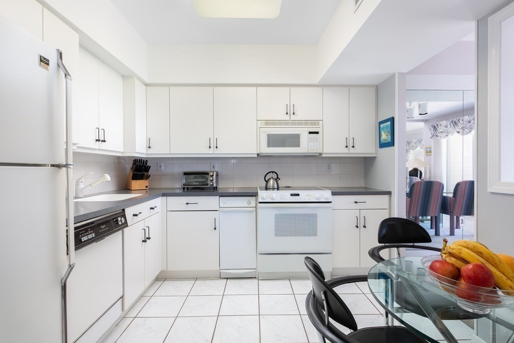 39 Harbourside Road, Unit 44 Quincy, MA 02171 - Photo 6 of 21 a kitchen with stainless steel appliances cabinets a sink and a refrigerator