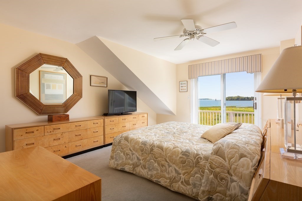 39 Harbourside Road, Unit 44 Quincy, MA 02171 - Photo 8 of 21 a bedroom with a large bed and a flat tv screen on dresser