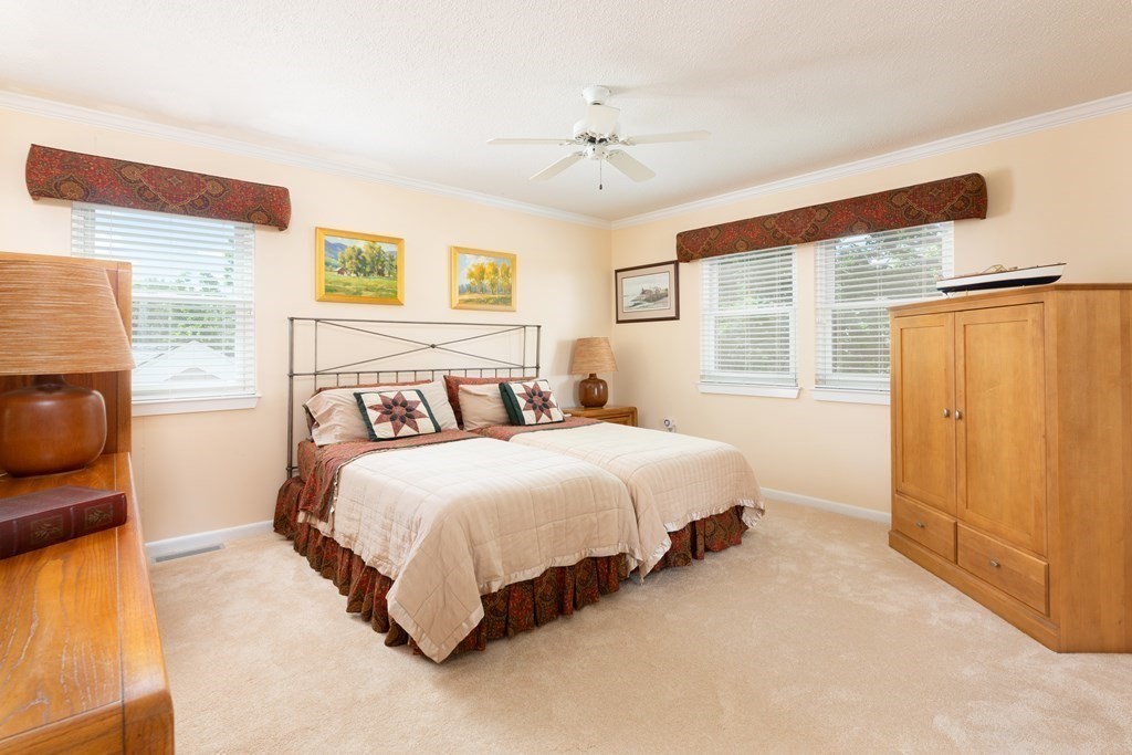 39 Harbourside Road, Unit 44 Quincy, MA 02171 - Photo 10 of 21 a bedroom with a bed and wooden floor