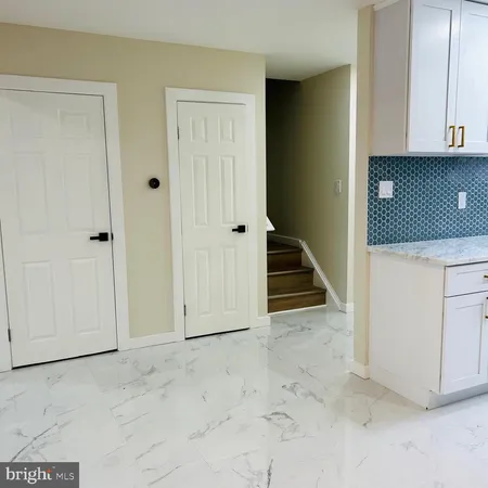 a kitchen with stainless steel appliances a stove a microwave a sink and cabinets