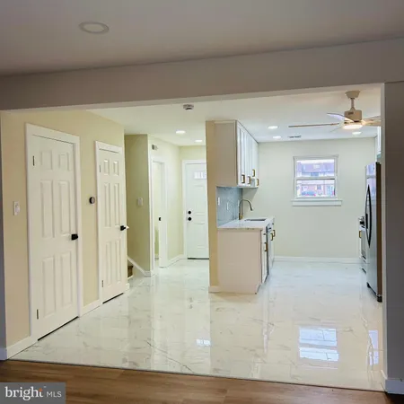 a view of kitchen with furniture and refrigerator