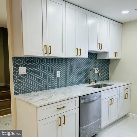 a kitchen with a sink cabinets and utility