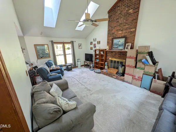 a view of a hallway with wooden floor and furniture