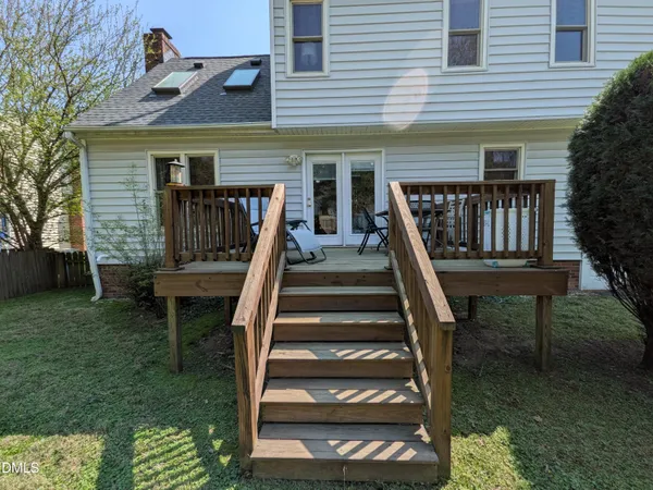 a view of house with backyard and sitting area