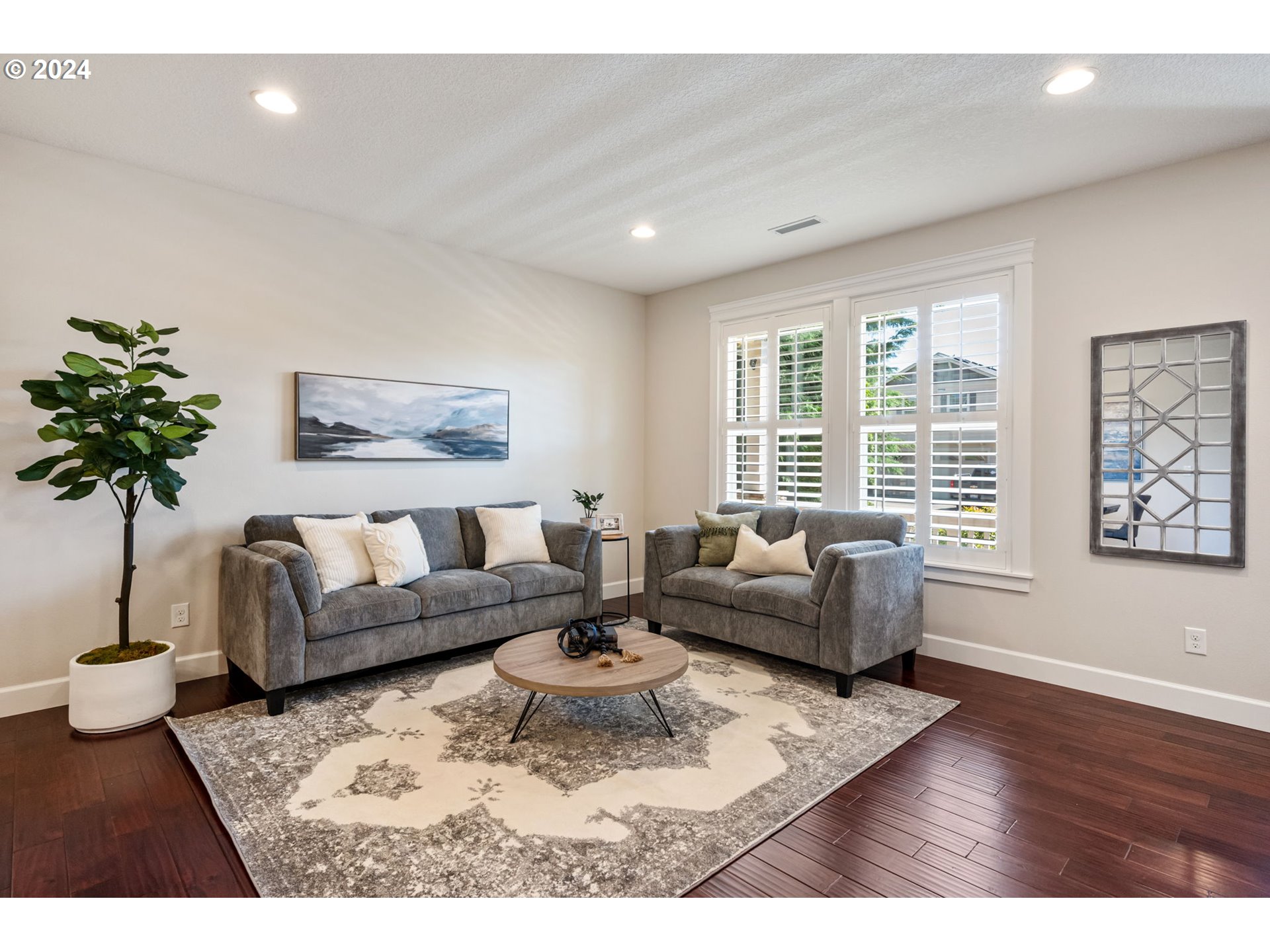 151 North 40th Avenue Ridgefield, WA 98642 - Photo 6 of 42 a living room with furniture and a large window with potted plants