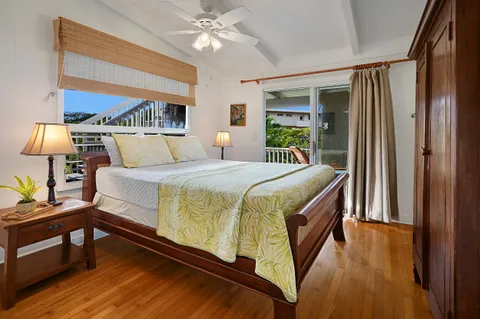 a bedroom with a bed a lamp on the table and a window